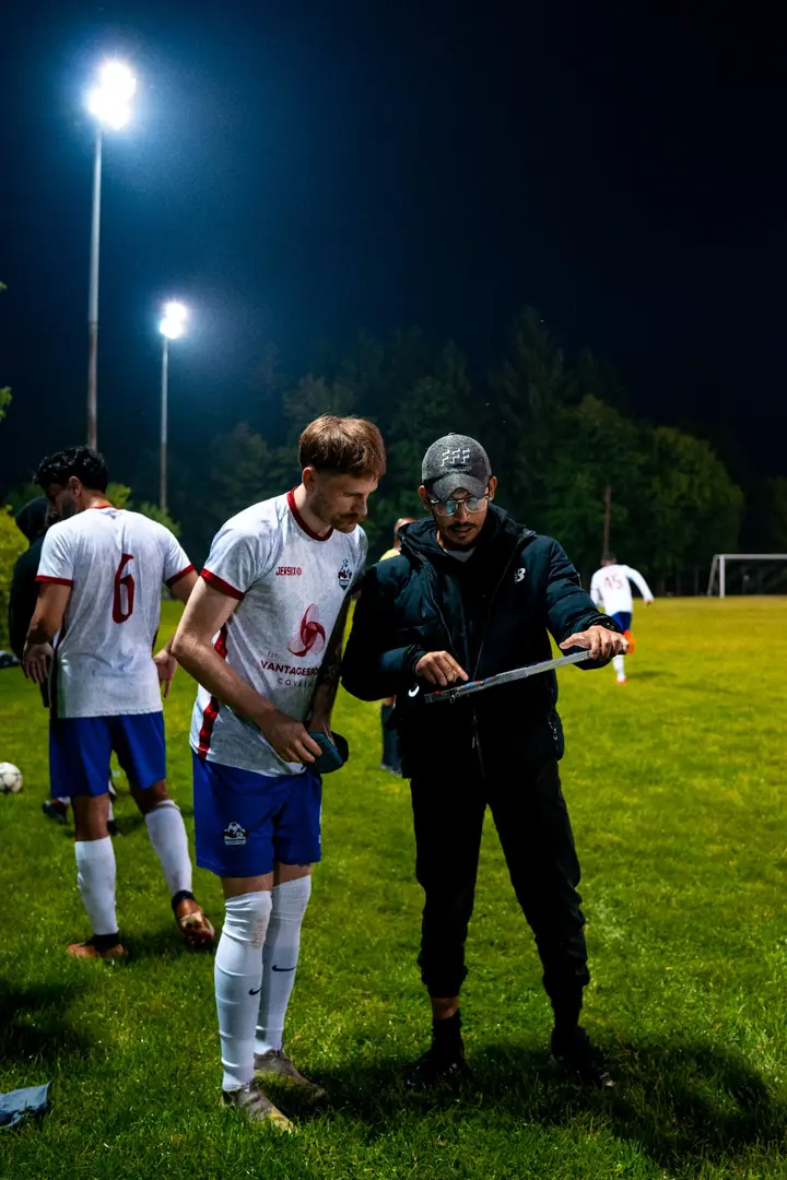 Coach reviewing play with an Inter Ottawa player